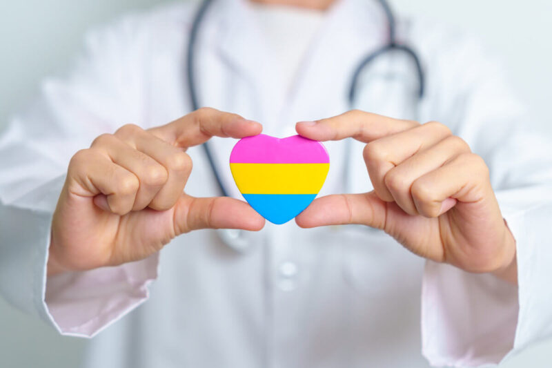 Ärztliche Hände halten ein Herzsymbol – Symbolbild für STI Selbsttest für schwule Männer und sexuelle Gesundheit. Englisch: Medical hands holding a heart symbol representing STI self-test for gay men and sexual health.